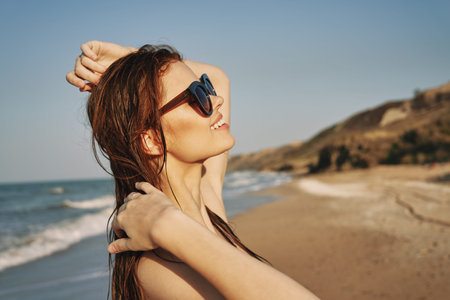 pretty woman in black swimsuit posing tanning tropicsの写真素材