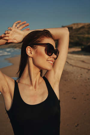 cheerful woman sunglasses posing black swimsuit islandの写真素材