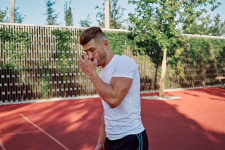 man doing exercises outdoors on the playgroundの写真素材