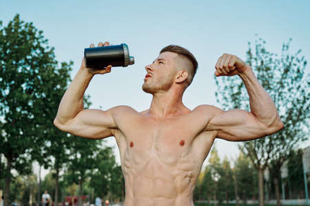 sports muscular man in the park healthy food fitnessの写真素材