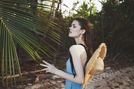 woman in swimwear palm leaf jungle island beach sunの写真素材