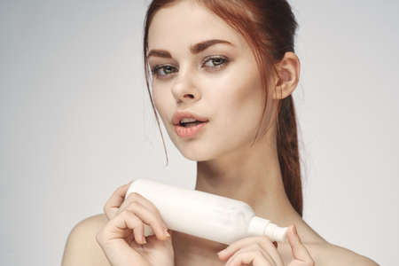 woman with bare shoulders cosmetics procedures skin care creamの写真素材