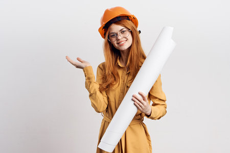 female engineer in orange hard hat blueprints architectの写真素材