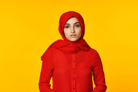 pretty woman attractive eyes fun gesture hands yellow backgroundの写真素材