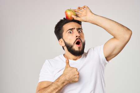 bearded man in white t-shirt apples holding healthy foodの写真素材