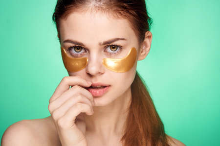pretty woman naked shoulders gold face patches cosmeticsの写真素材
