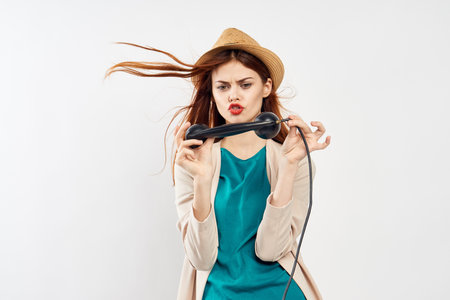 woman with antique phone in hands emotions fashion posing retro