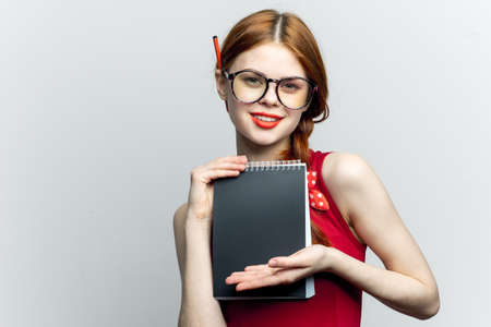 Business woman in red dress notebook pencil professionalsの写真素材