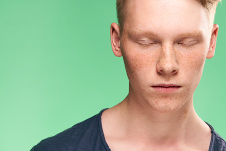 Redhead guy posing freckles close-up studio lifestyleの写真素材