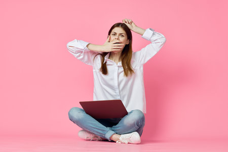 woman with laptop on pink background online shopping entertainment
