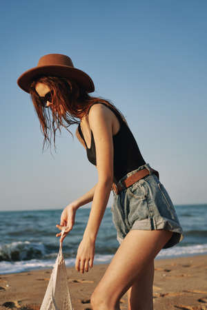 woman in trendy summer clothes by the ocean vacation sunの写真素材