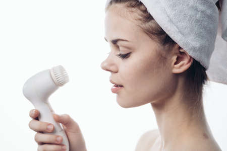 pretty woman with towel on head close-up facial massageの写真素材