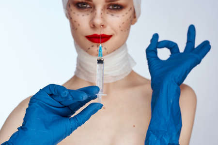 female patient Red lips plastic surgery operation bare shoulders studio lifestyleの写真素材