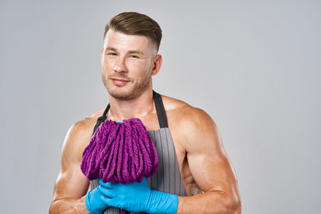 a man with a mop in his hands cleaning service posing