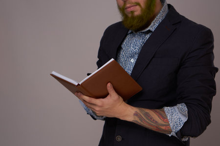 manager in a jacket with a notebook in his hands work officeの写真素材