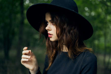 woman dressed as a witch in the forest Halloween fantasy ritualの写真素材
