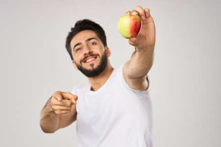 bearded man in white t-shirt apple health proper nutritionの写真素材