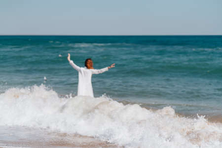 Woman in white dress near the ocean walk fresh air landscapeの写真素材
