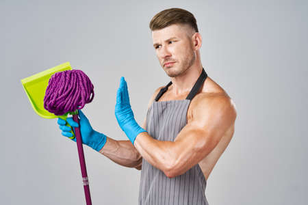 pumped up cleaner in aprons with a mop in the hands of providing servicesの写真素材