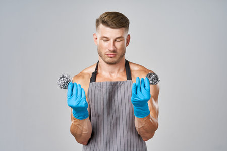 a man in an apron with rubber gloves and an iron sponge service