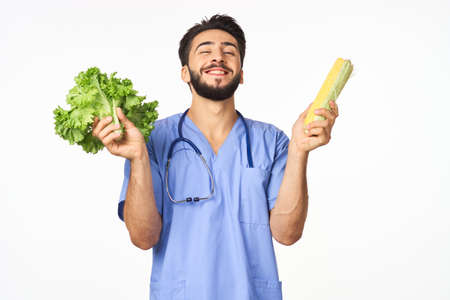 Cheerful dietitian with vegetables in hands vitamins healthy foodの写真素材