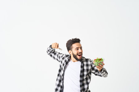 man in plaid shirt eating salad healthy foodの写真素材