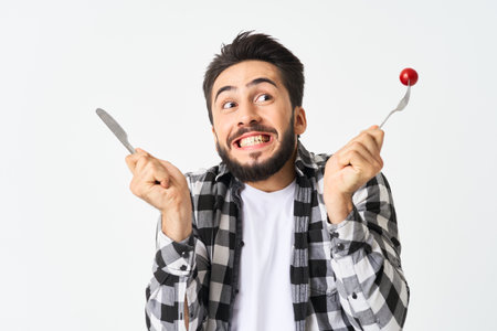 bearded man with kitchen utensils cherry tomatoes snack
