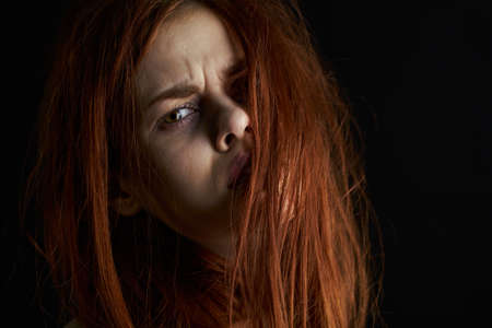 upset woman crying bruises under eyes depression dark backgroundの写真素材