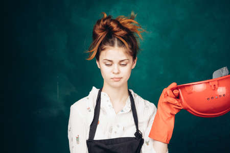 woman in black apron orange hard hat protection cleaningの写真素材