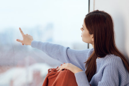 woman sitting on windowsill rest plaid morning lifestyle