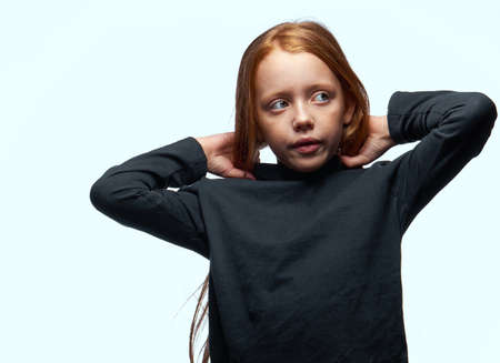 red-haired girl in a black sweater planning close-upの写真素材