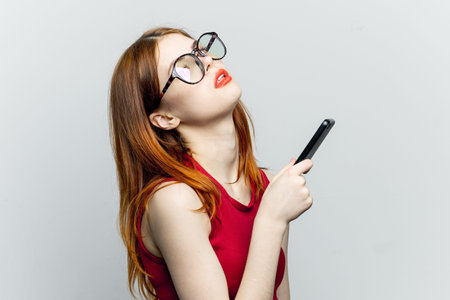 pretty woman in glasses with phone in hands communication technology