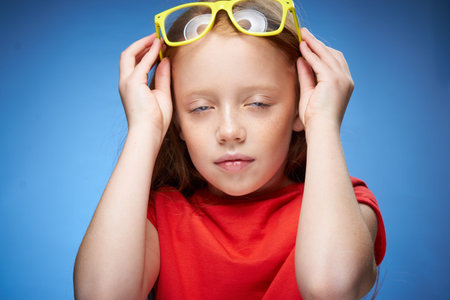 cute red-haired girl in red t-shirt emotions blue background