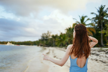 woman in blue swimsuit on the beach island lifestyle