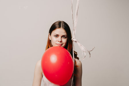 cheerful woman in a dress of colorful balloons