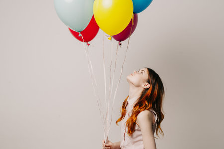 cheerful woman in a dress of colorful balloonsの写真素材