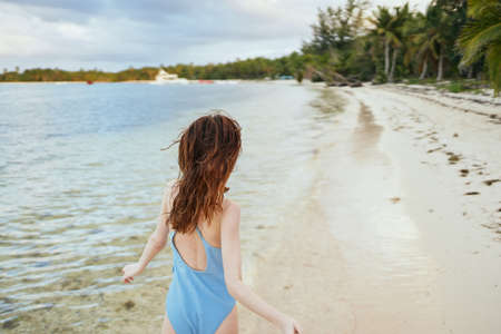 woman in blue swimsuit on the beach island lifestyleの写真素材