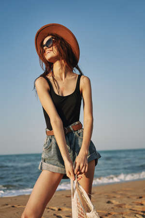 woman in trendy summer clothes by the ocean vacation sunの写真素材