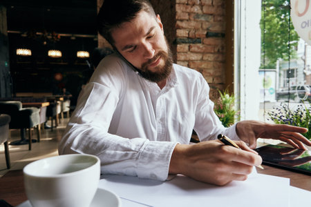 business man in a cafe with a tablet in his hands technology workの写真素材