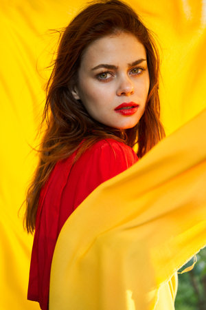 pretty woman in red dress nature yellow cloth on background
