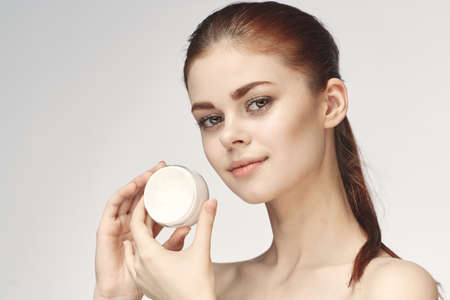 woman with jar of cream makeup face skin care close-upの写真素材