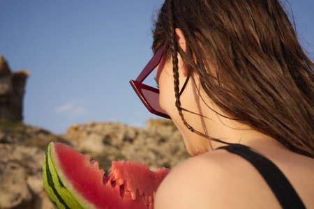 Cheerful woman eating watermelon nature summer vacation