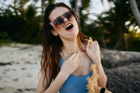 woman wearing sunglasses blue swimsuit island beach sunの写真素材