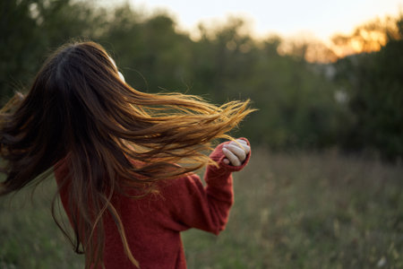 woman outdoors in a field walk fresh airの写真素材