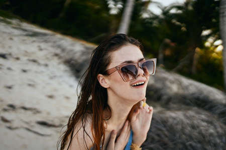 woman wearing sunglasses blue swimsuit island beach sunの写真素材