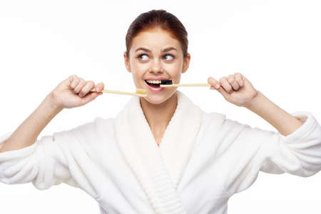 contact woman in white robe toothbrushes bathroom hygieneの写真素材
