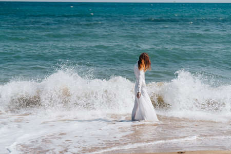 beautiful woman in a white dress by the ocean Lifestyleの写真素材