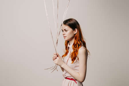 cheerful woman in a dress of colorful balloonsの写真素材