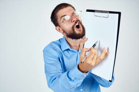 bearded man in blue shirt documents manager professionalの写真素材