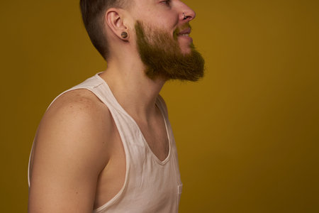 Cheerful bearded man in a white T-shirt with hooligan tattoos on his armsの写真素材